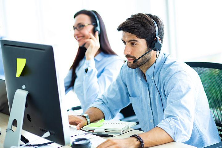 Two people working in front of their computers