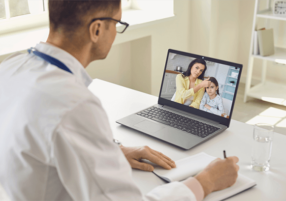 Someone on video call with a woman and her daughter