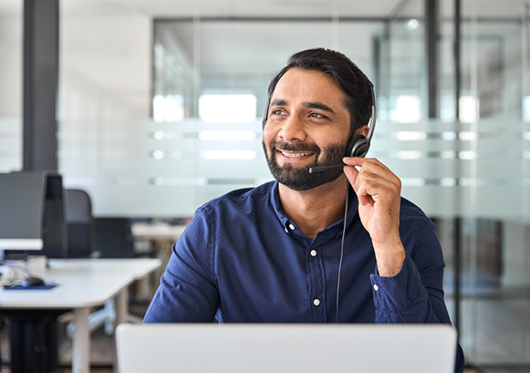 A guy on a call in front of his laptop 