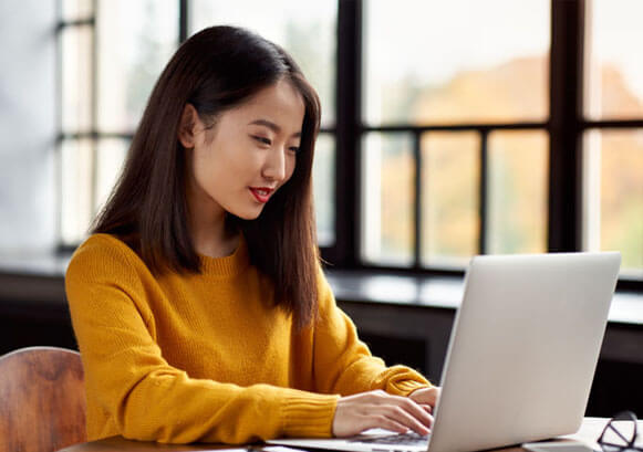 A woman working in front of her laptop