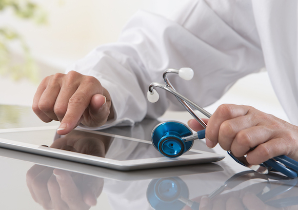 A doctor with a tablet and a stethoscope 