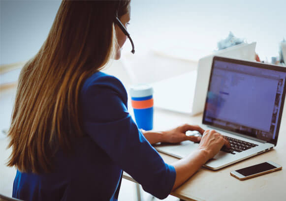 A woman working in front of her laptop