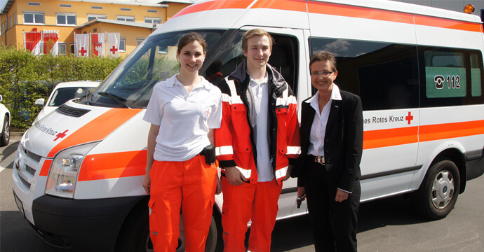 People in front of an ambulance