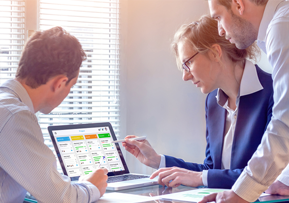 Three people looking at a laptop screen