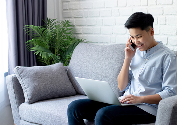 Someone on a sofa having a phone call