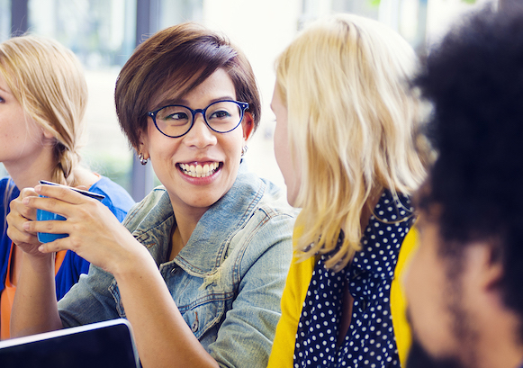 Two women looking at each other and smiling