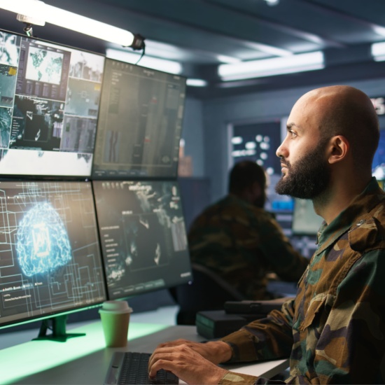 Man working on severals screens