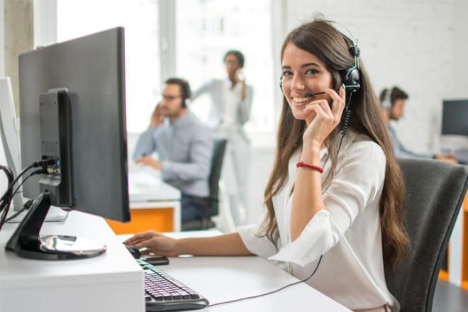 A woman working in her desk and on the phone