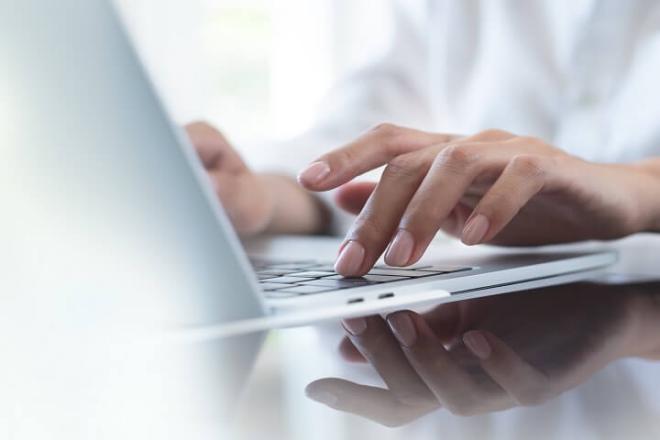 Someone typing on a computer