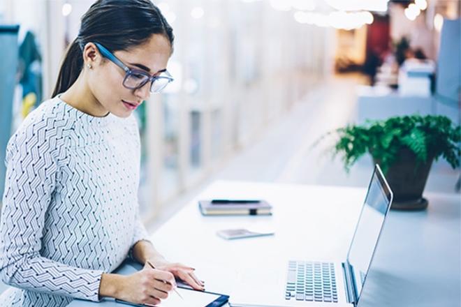 A woman taking a note on her iPad