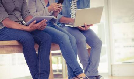 Three creative business team working on electronic devices