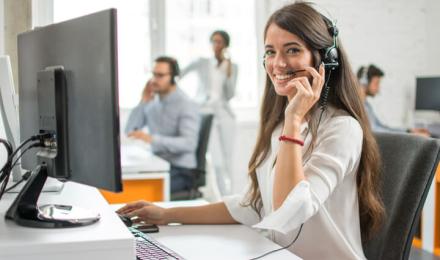A woman working in her desk and on the phone
