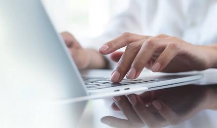 Someone typing on a computer