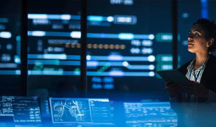 A woman looking at her tablet in the dark