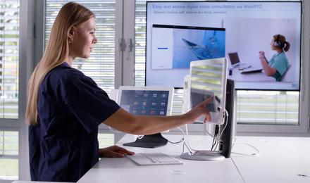 Woman touching computer screen HiMed