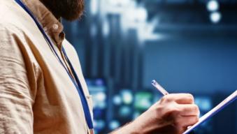 man writing on a tablet