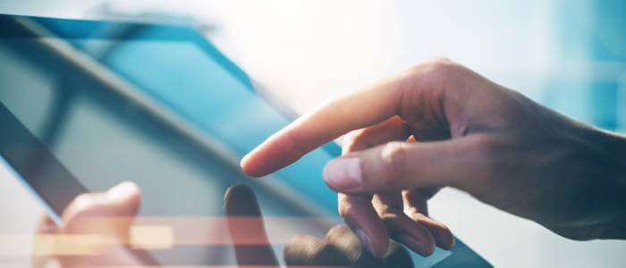 Someone typing on a tablet