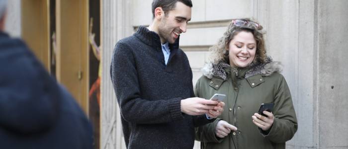 Two people looking at their phones