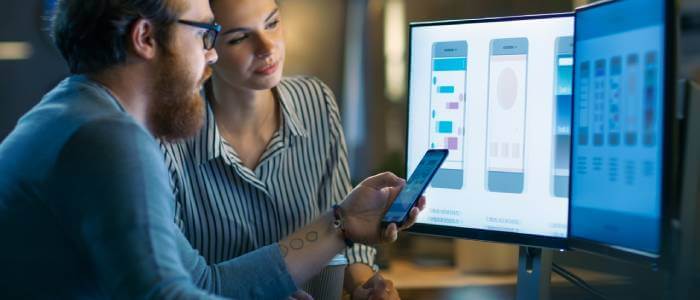 Two people looking at a monitor