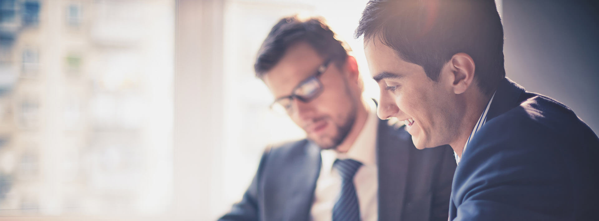 Two men collaborating together