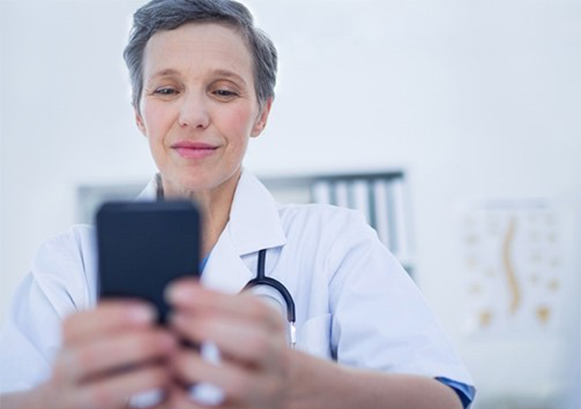 Doctor looking at her mobile phone