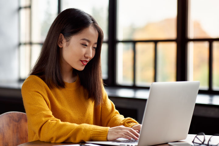 A woman working in front of her laptop