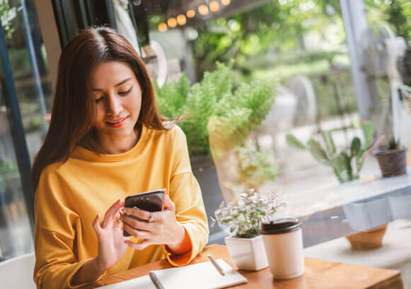 A woman on a terrace looking at her phone