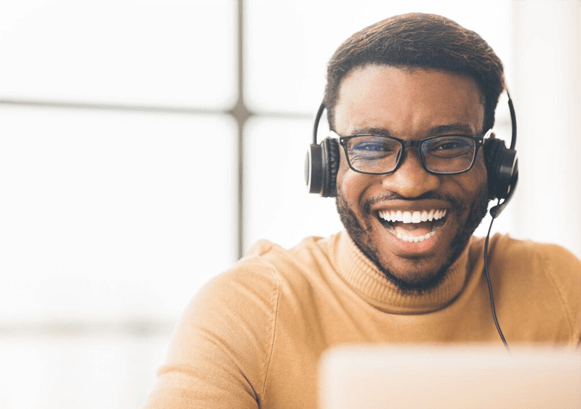 A guy smiling while on a phone