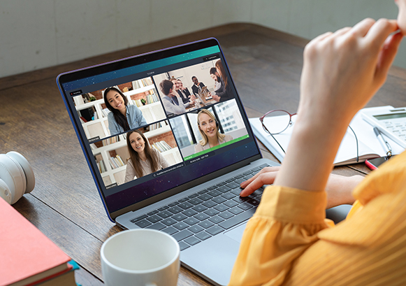 Someone in front of a laptop during an online meeting