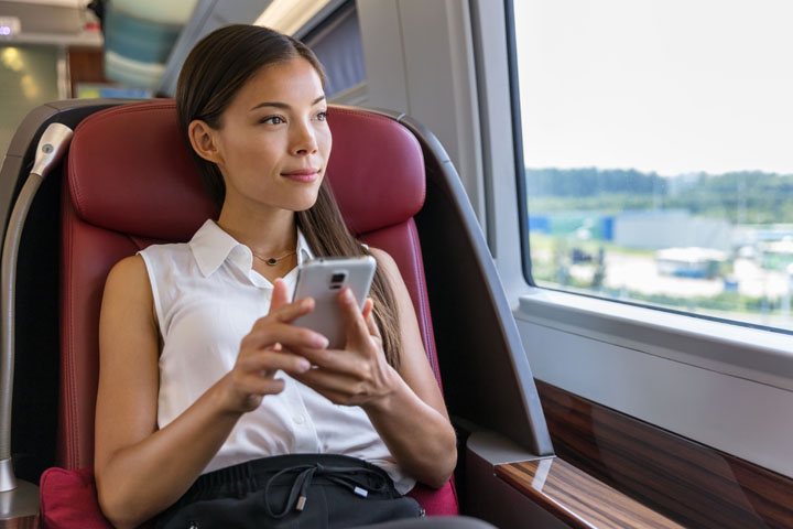 A woman looking at her phone in a train