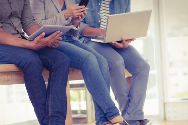 Three creative business team working on electronic devices