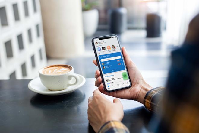 Someone looking at a phone in a coffee shop
