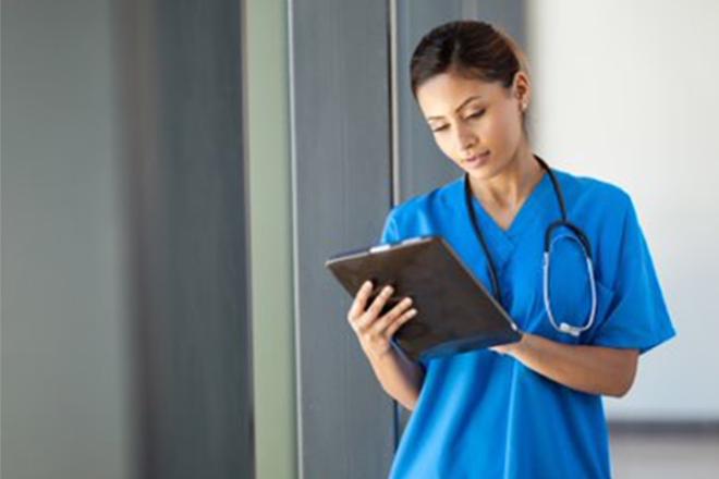 Nurse looking at a tablet