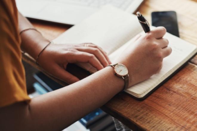 hands writting on a notebook