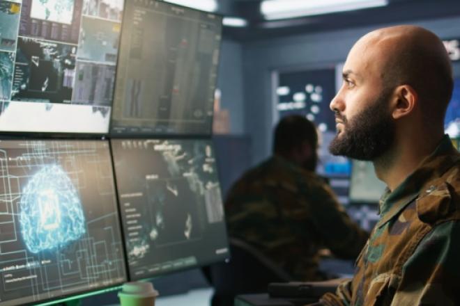Man working on multiple screens