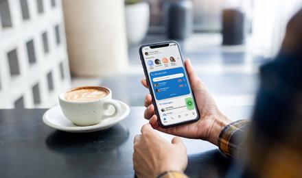 Someone looking at a phone in a coffee shop
