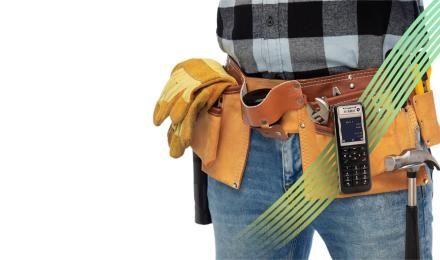 A guy holding a phone in his belt