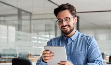 Man looking at his tablet and smiling