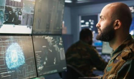 Man working on multiple screens