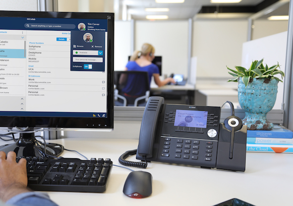 A phone and a monitor in a desk