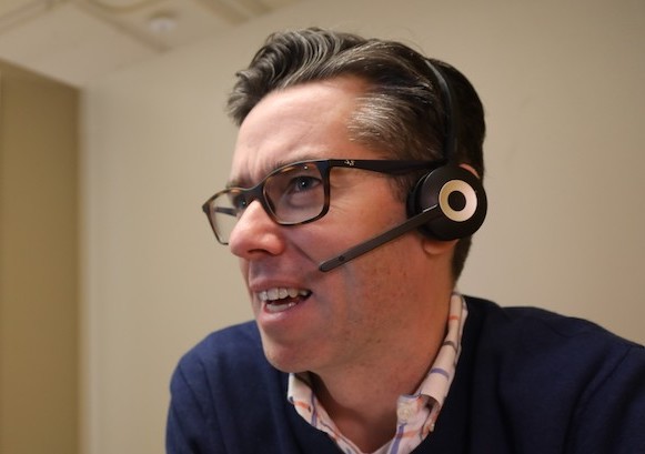 A guy on a phone with his professional headset