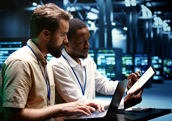 Two guys collaborating in a server room