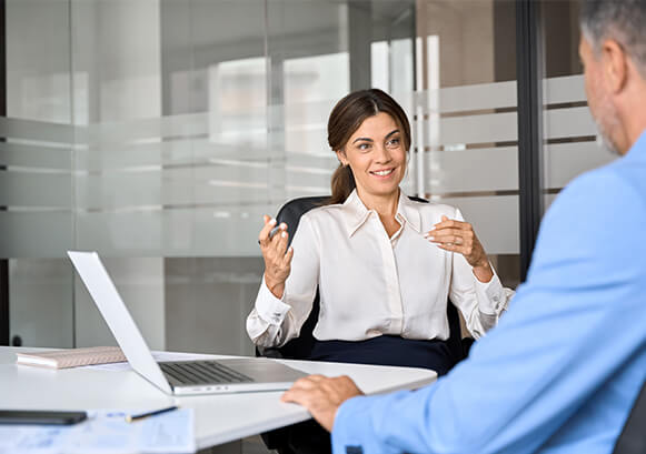 A woman and a man talking in an office