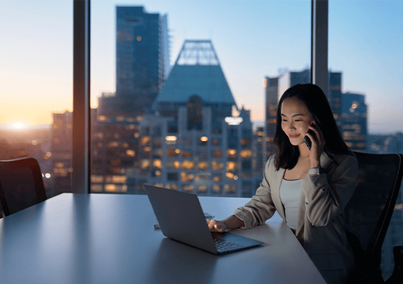 Woman calling on the phone in a building early in the morning