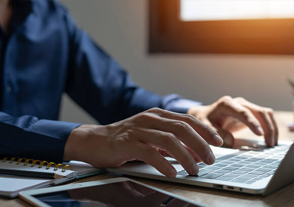 Someone typing on his laptop