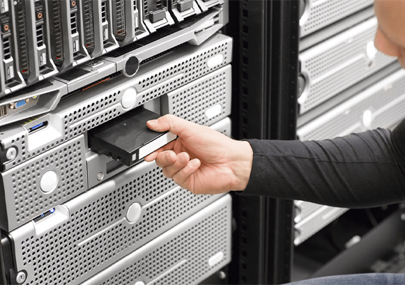 Someone working on a server rack 