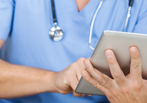 A doctor holding a tablet