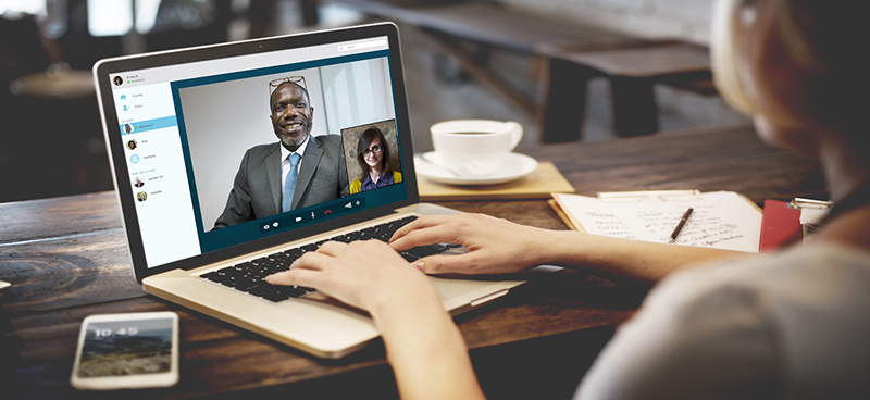Someone looking at a laptop during a video conference