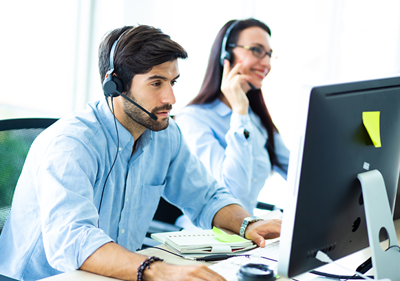 A woman and a man working in a contact center