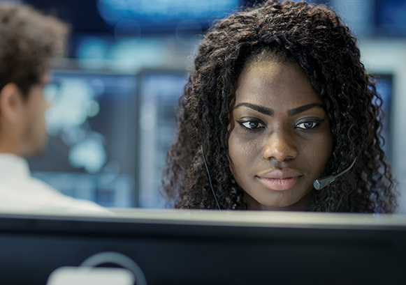 A woman on a call in front of her monitor